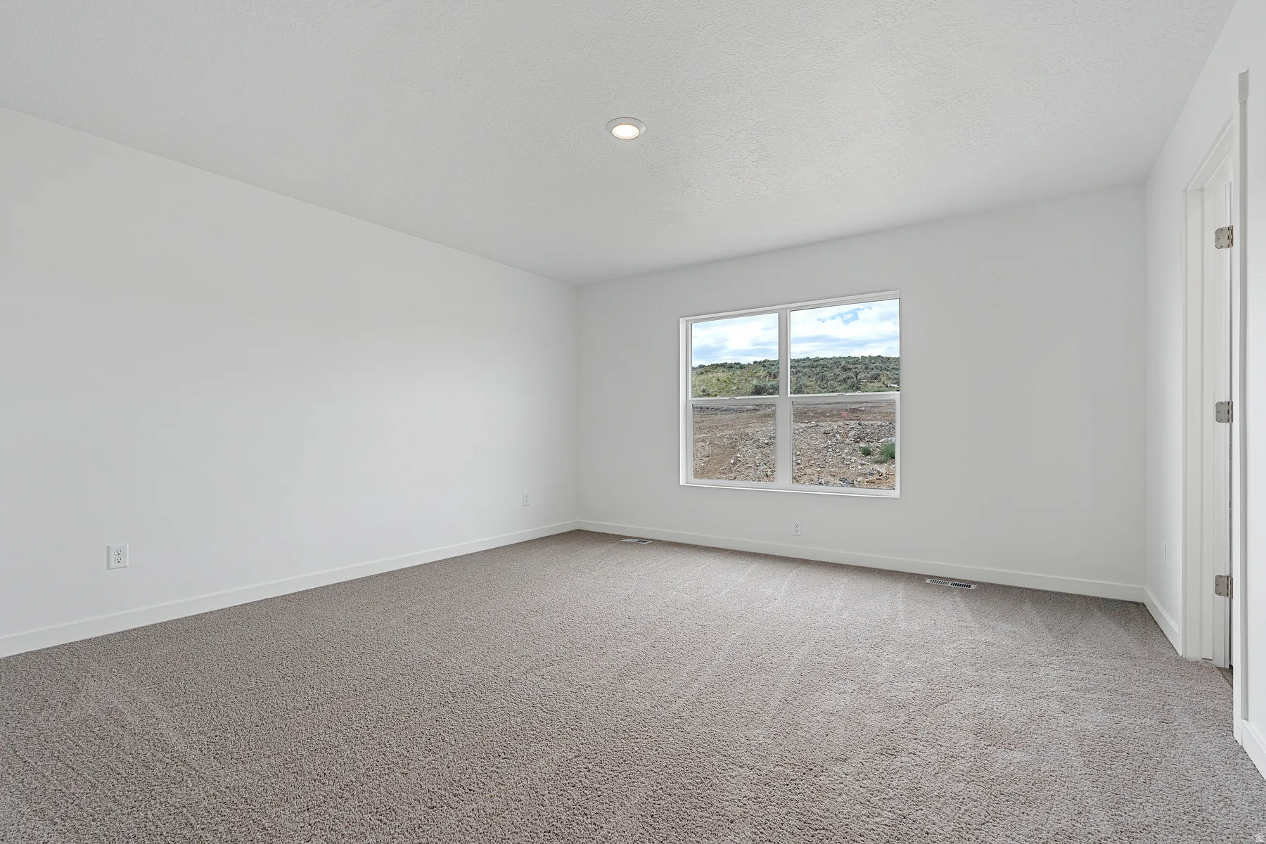 Spare room featuring baseboards and carpet floors