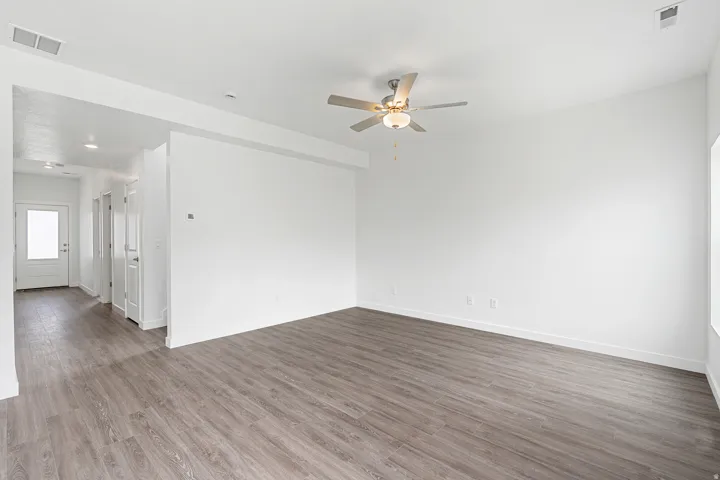 Spare room with ceiling fan and dark wood-style flooring