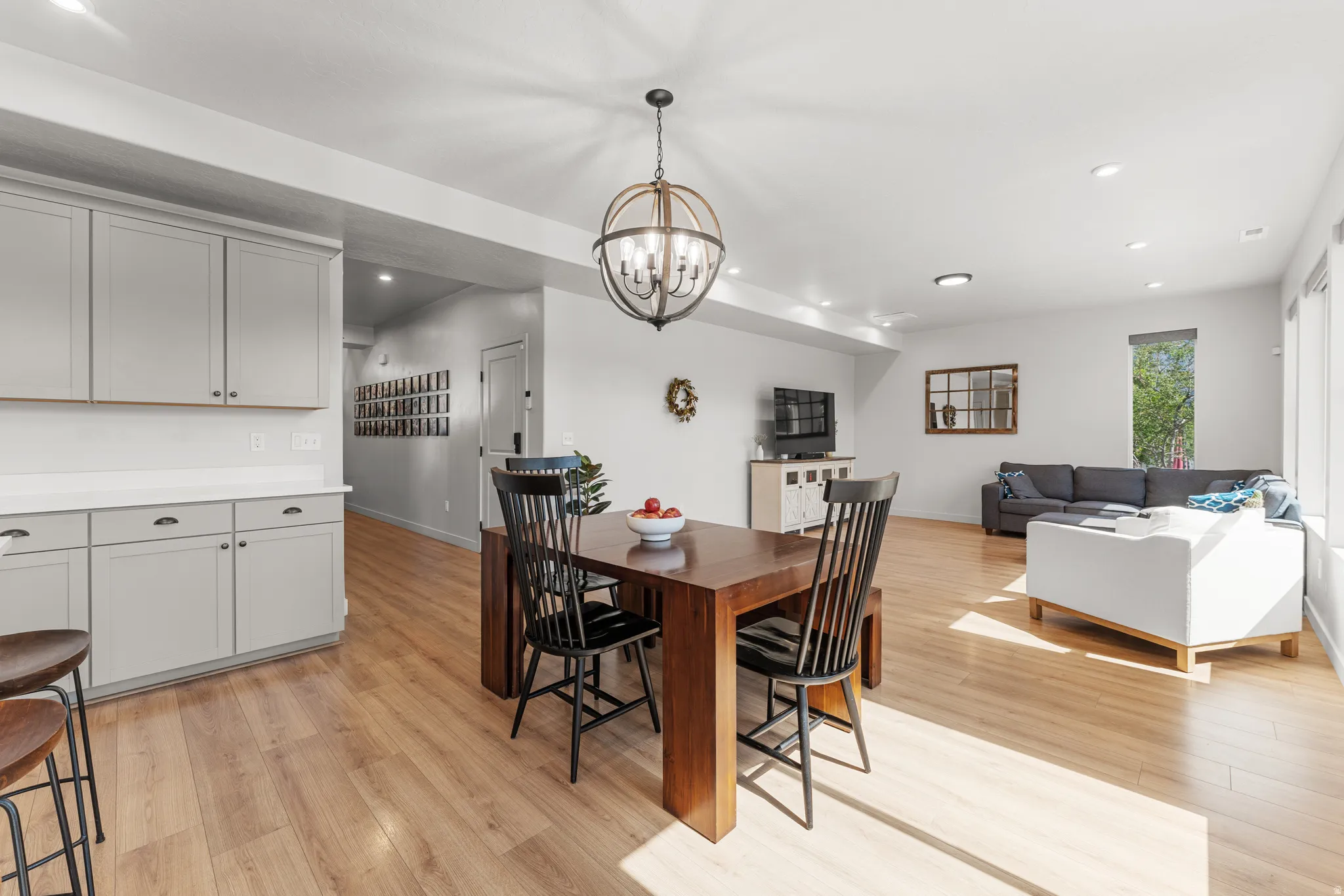 Dining area featuring light wood-type flooring and suspended lighting