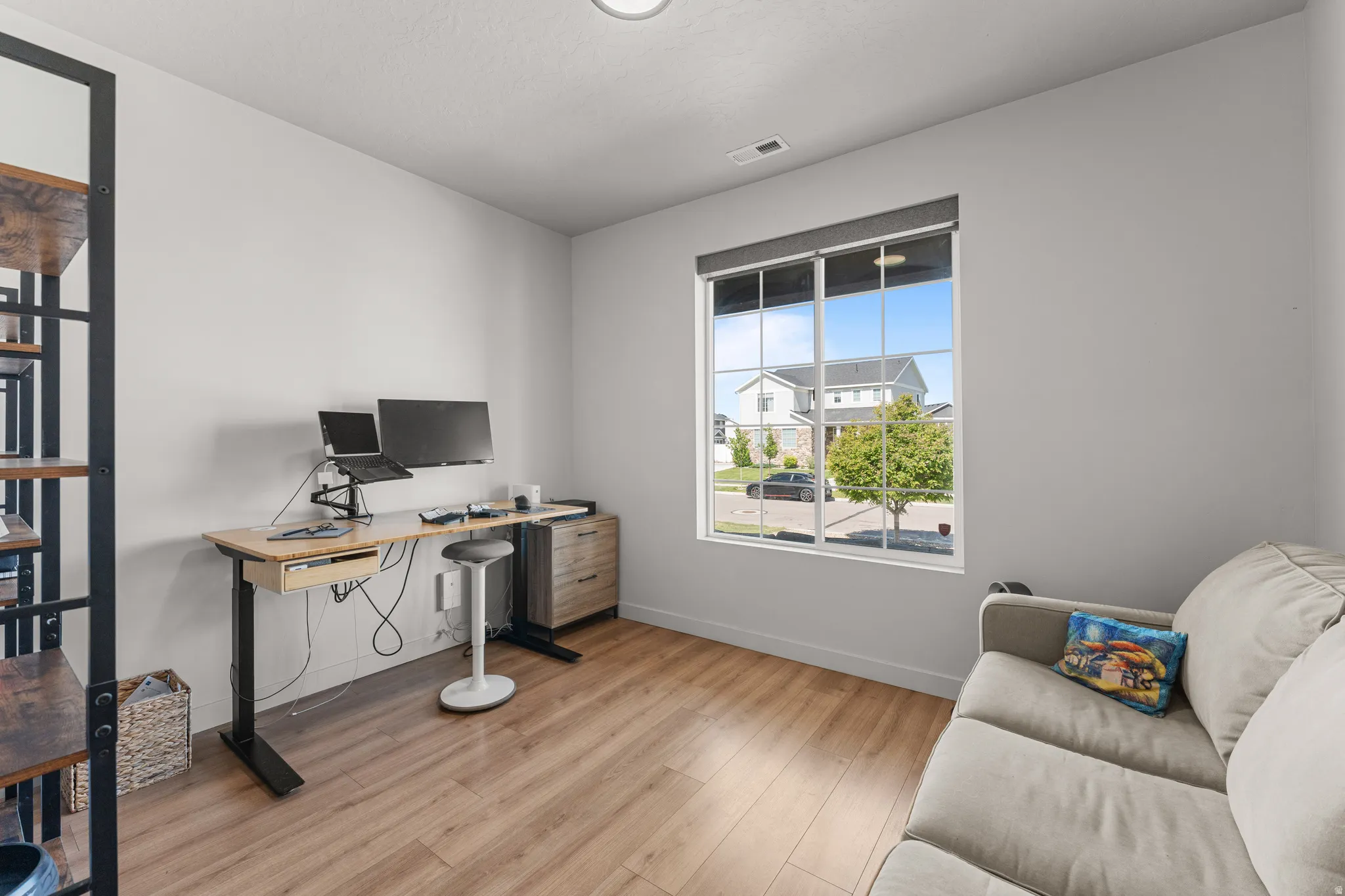 Office space featuring baseboards and light wood-style flooring