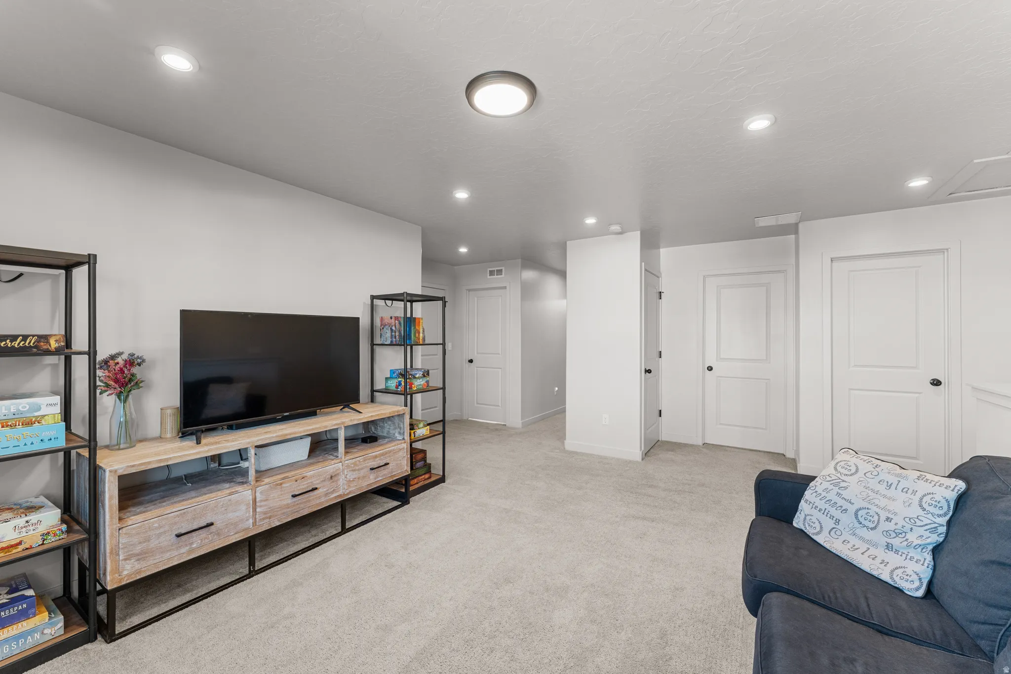Living room featuring light colored carpet and recessed lighting