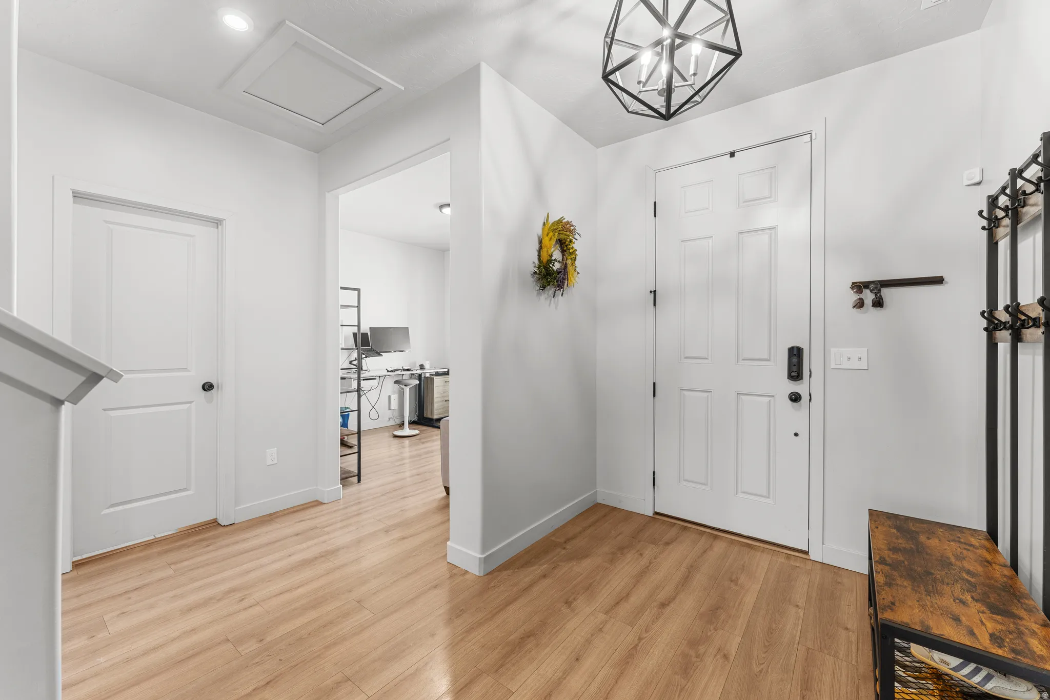 Entrance foyer featuring light wood-style floors and suspended lighting
