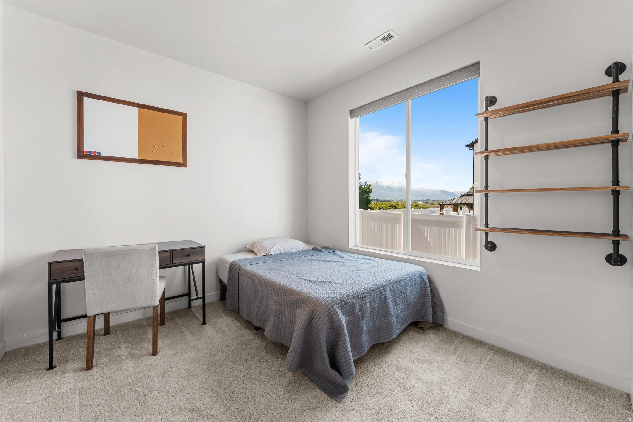 Bedroom featuring light colored carpet and baseboards