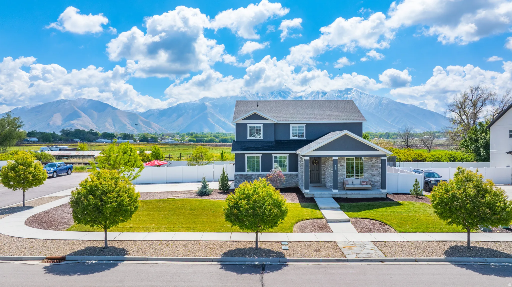 View of front of home featuring a mountain view, stone siding, and a porch
