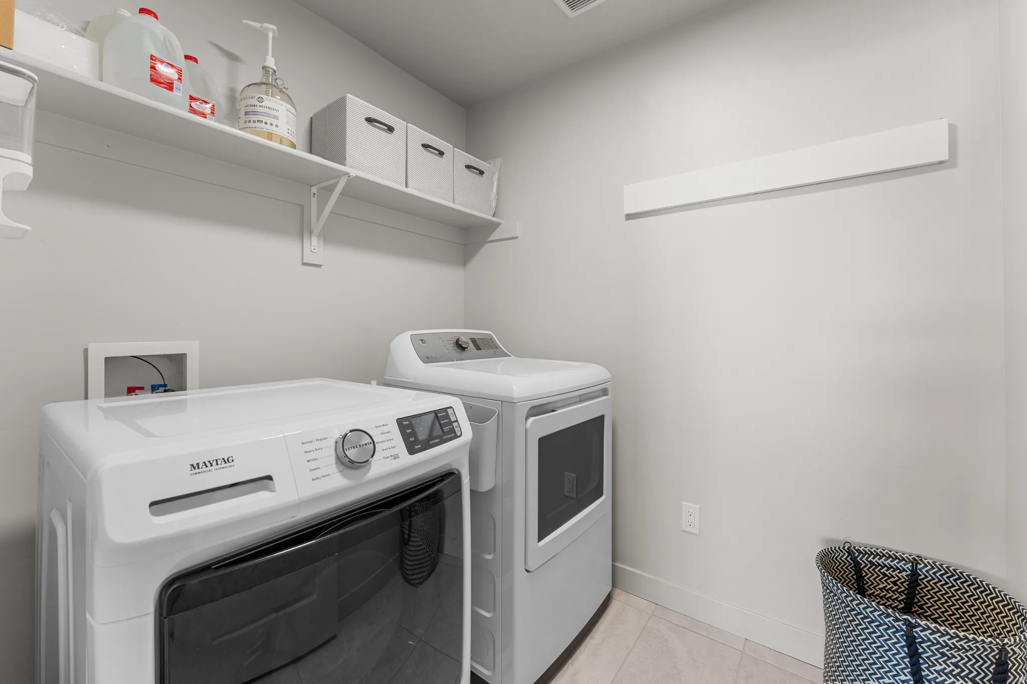 Laundry room featuring washer and clothes dryer and light tile patterned floors