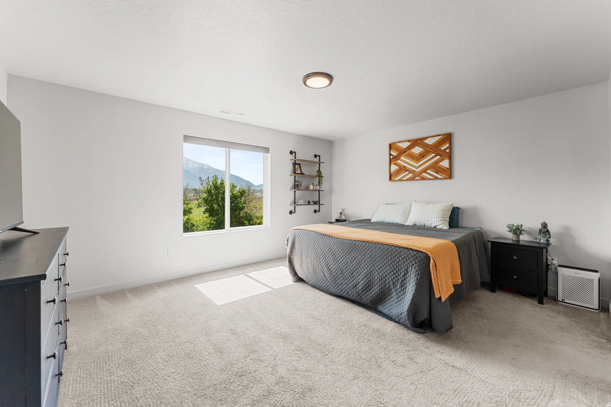 Bedroom featuring a mountain view and light carpet