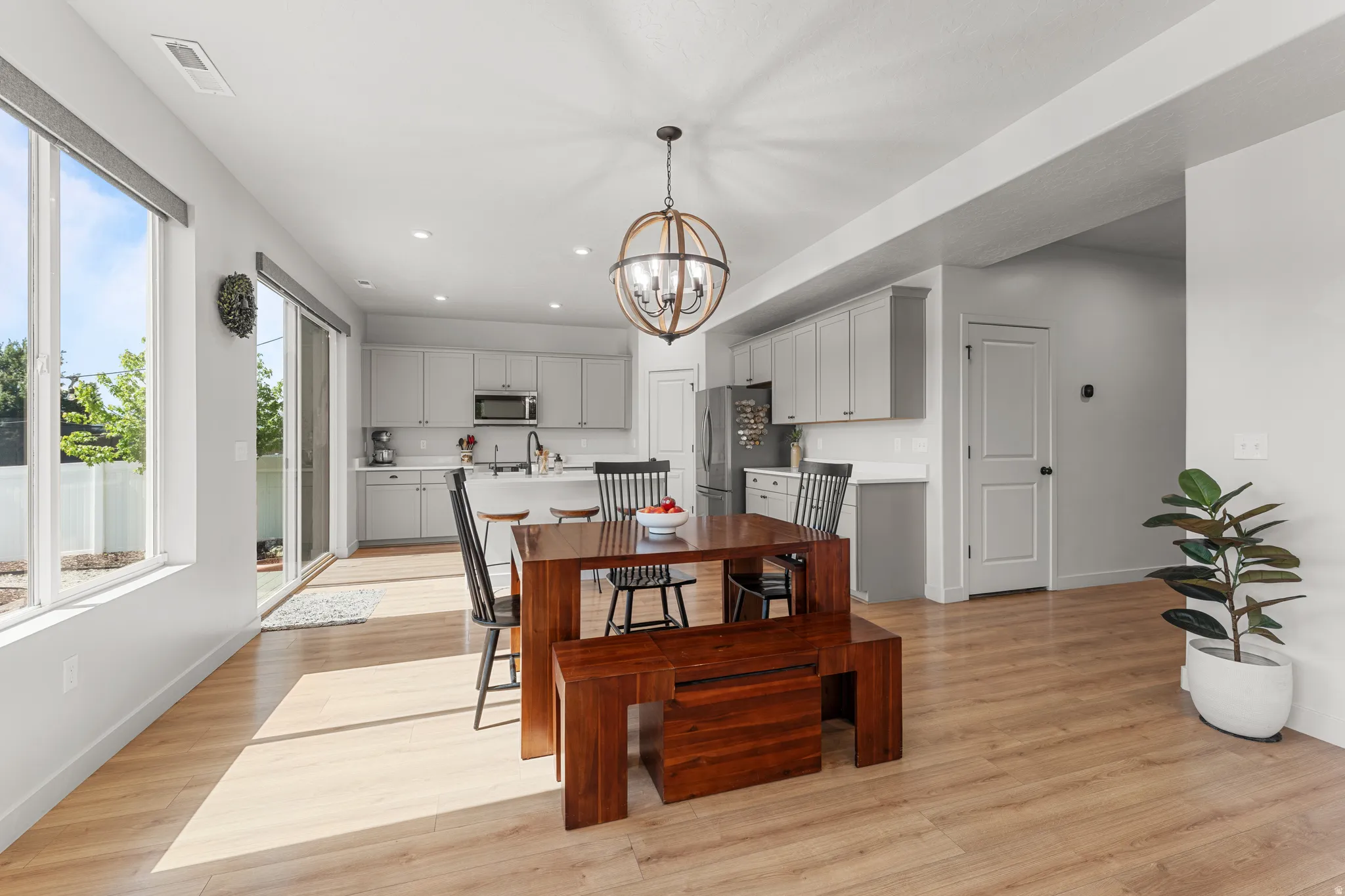Dining area with light wood-style floors and a chandelier
