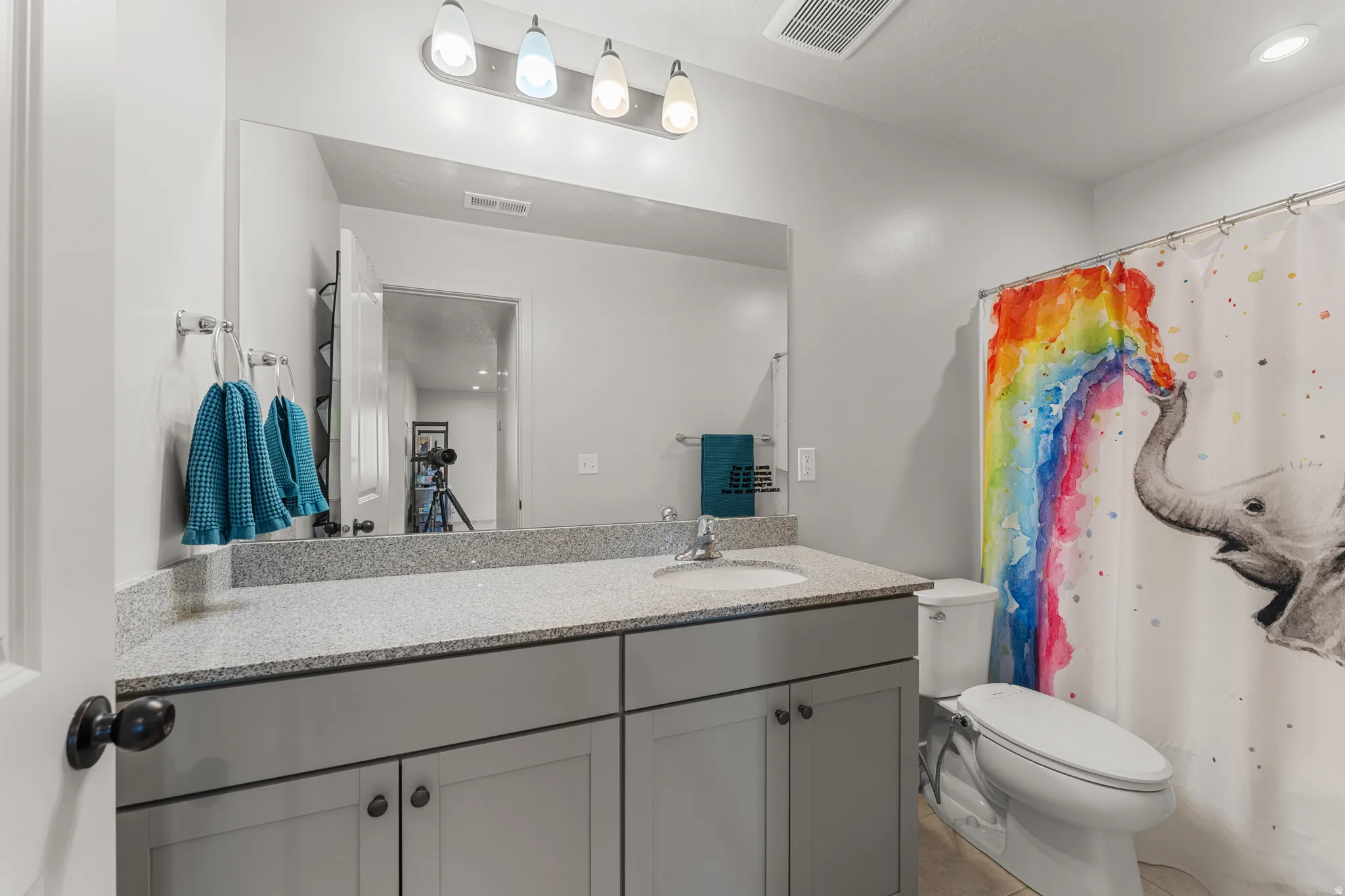 Bathroom with vanity, a shower with shower curtain, recessed lighting, and light tile patterned flooring
