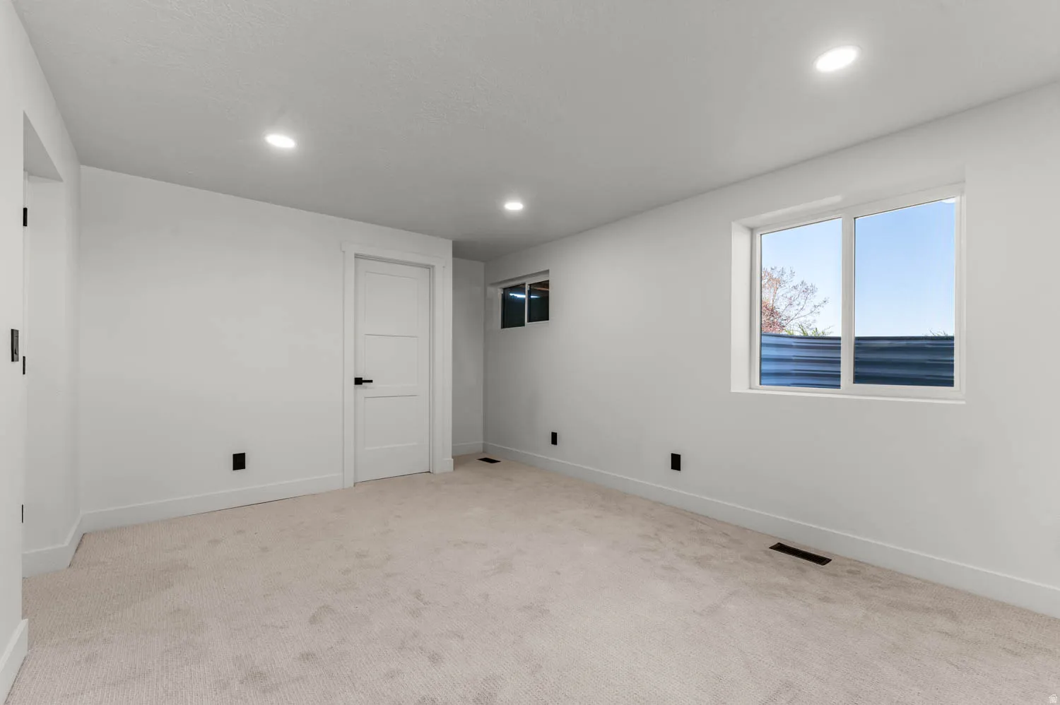 Basement featuring carpet and recessed lighting