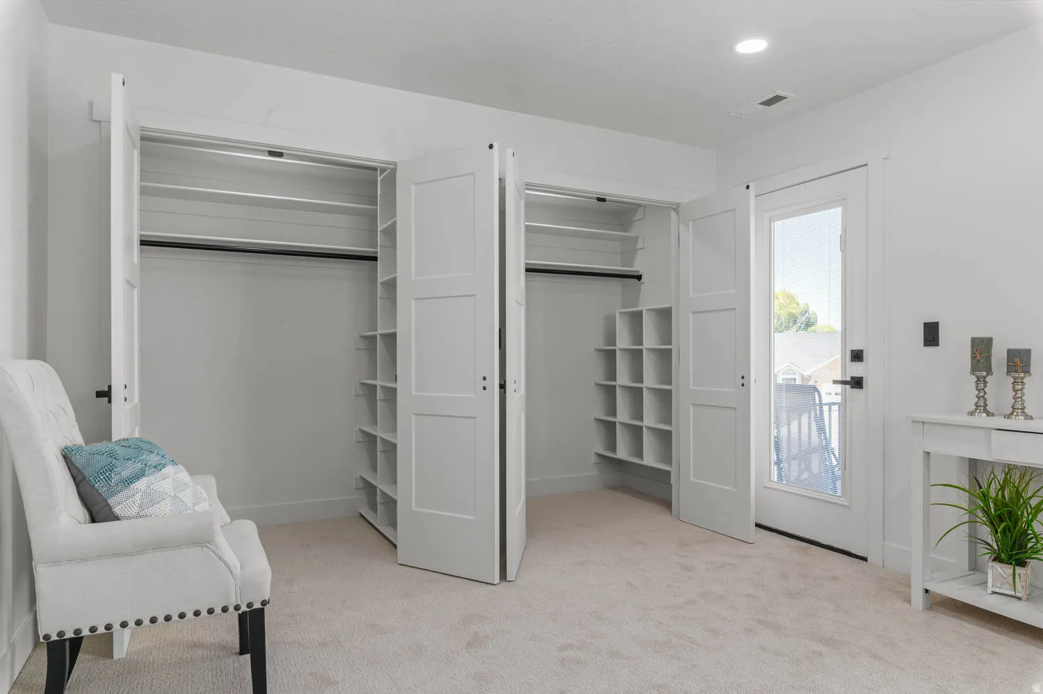Living area with light colored carpet and recessed lighting