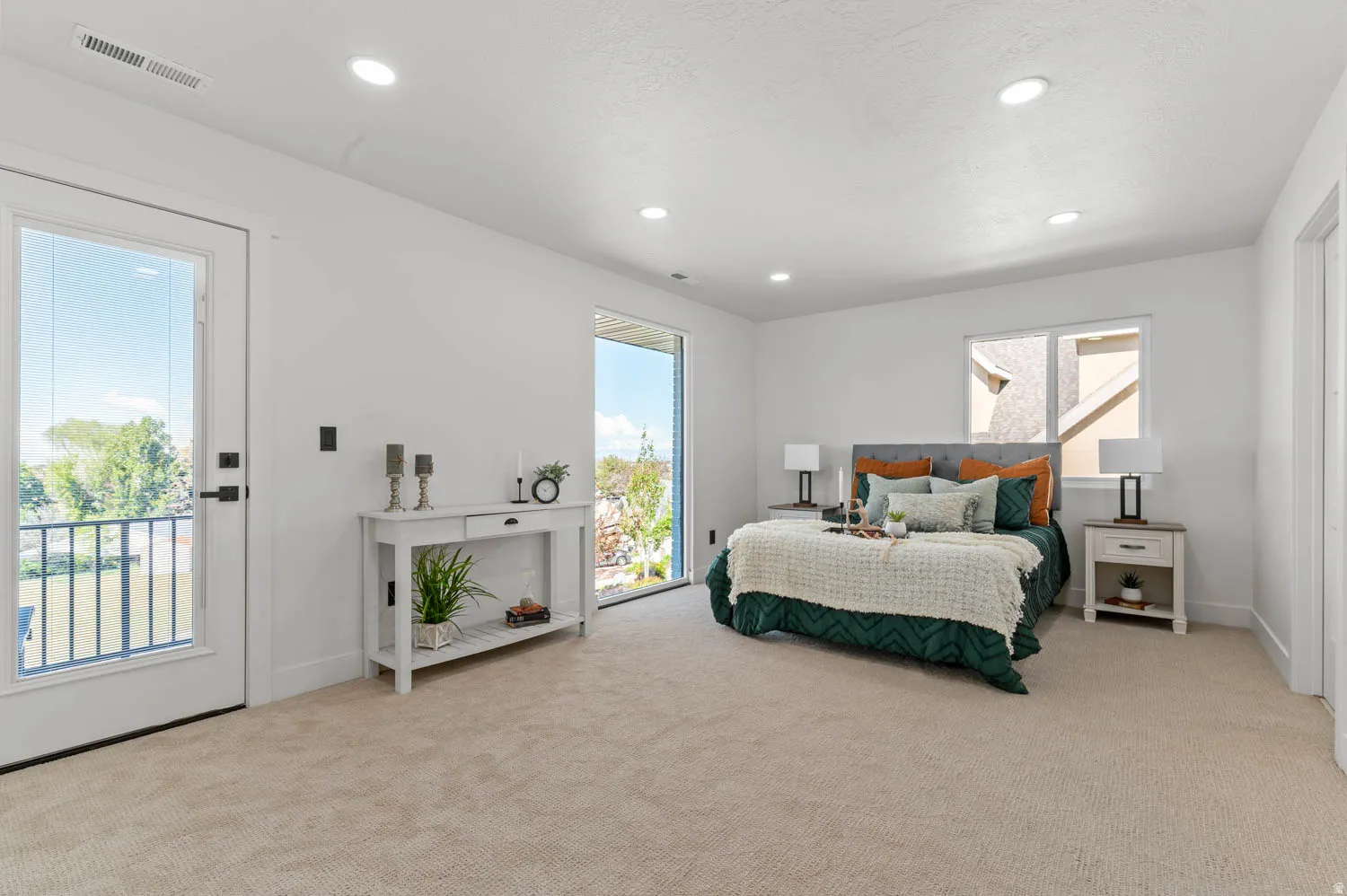 Bedroom with access to outside, light carpet, and recessed lighting