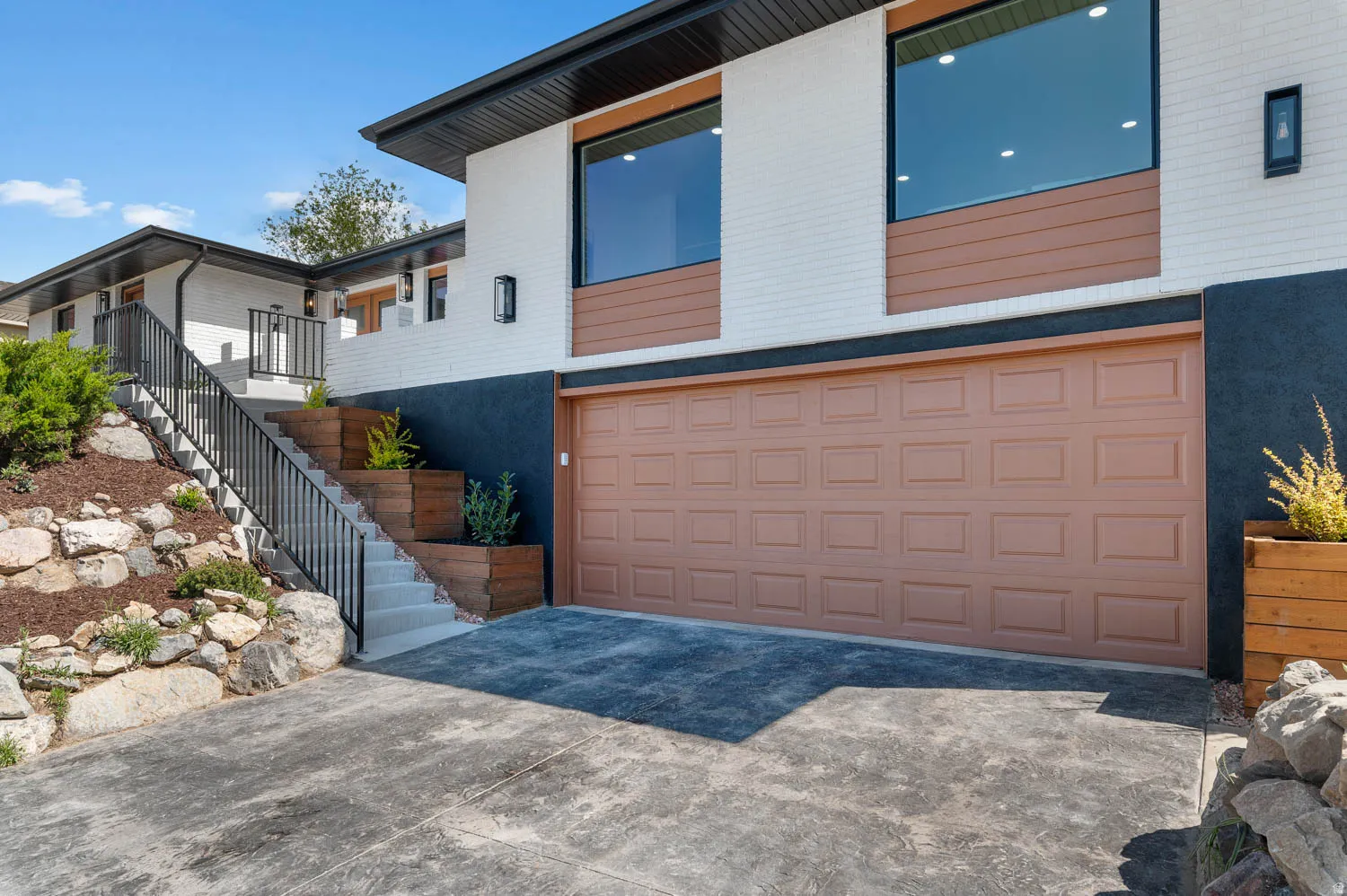 View of property exterior featuring driveway and an attached garage