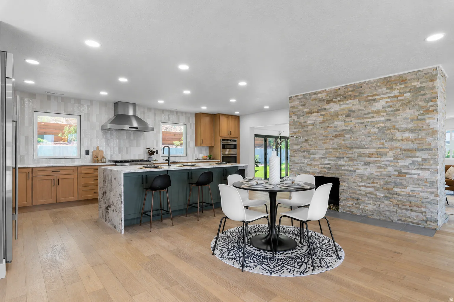Open-concept kitchen and dining area featuring light wood-finish flooring