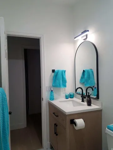 Half bathroom featuring vanity and light wood finished floors