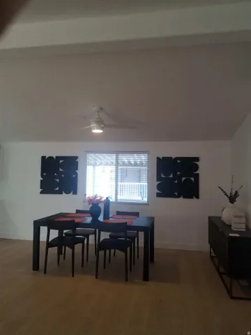 Dining space featuring a ceiling fan and light wood-style floors