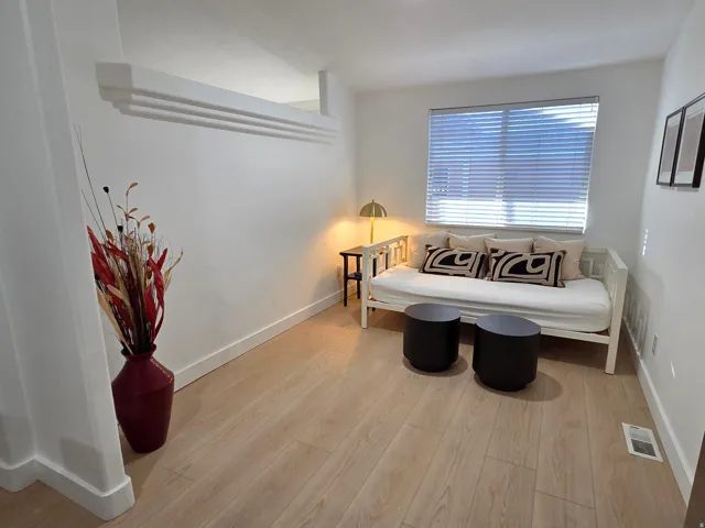 Living area with light wood-style floors and baseboards