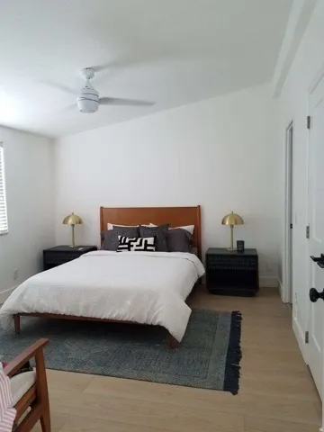 Bedroom with light wood finished floors and ceiling fan