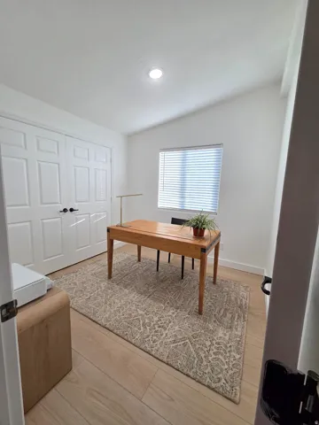 Office featuring light wood-type flooring and baseboards