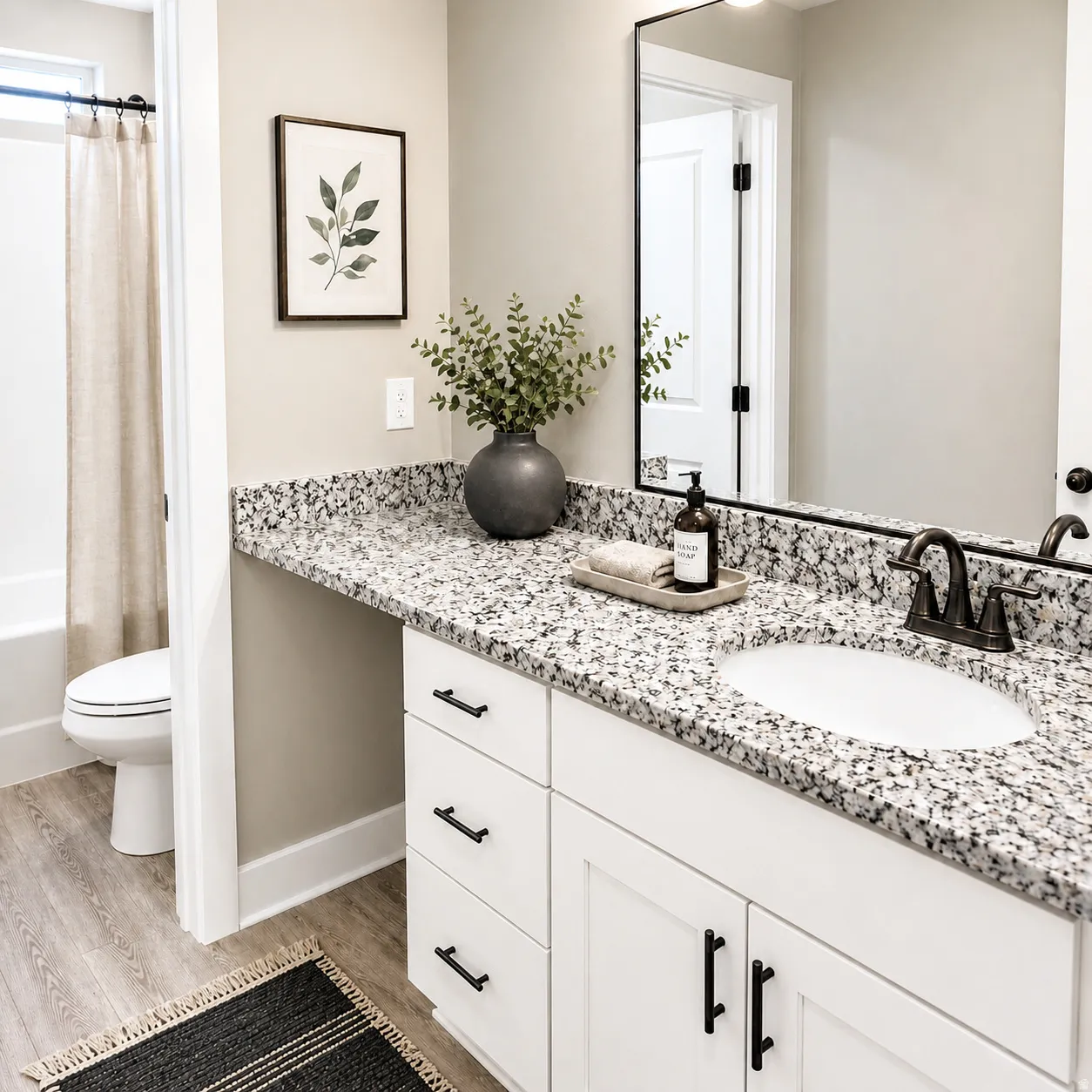 Full bathroom with light wood-style floors, vanity, and shower / bath combo with shower curtain
