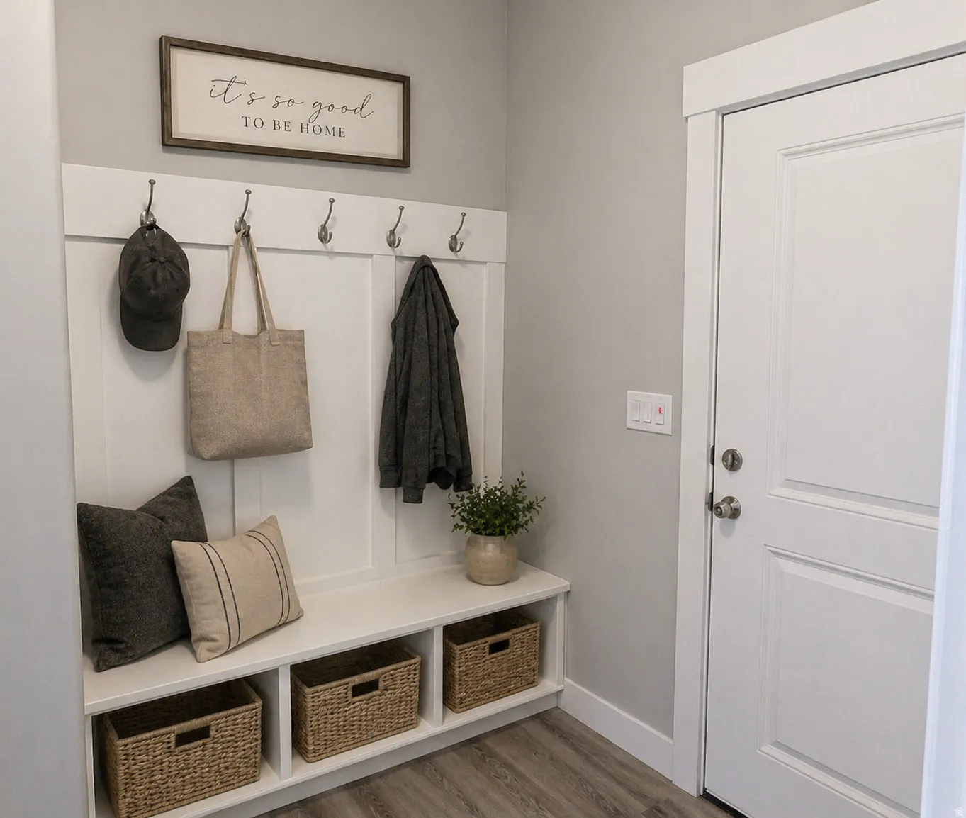 Virtually Staged Mudroom featuring wood finished floors and baseboards