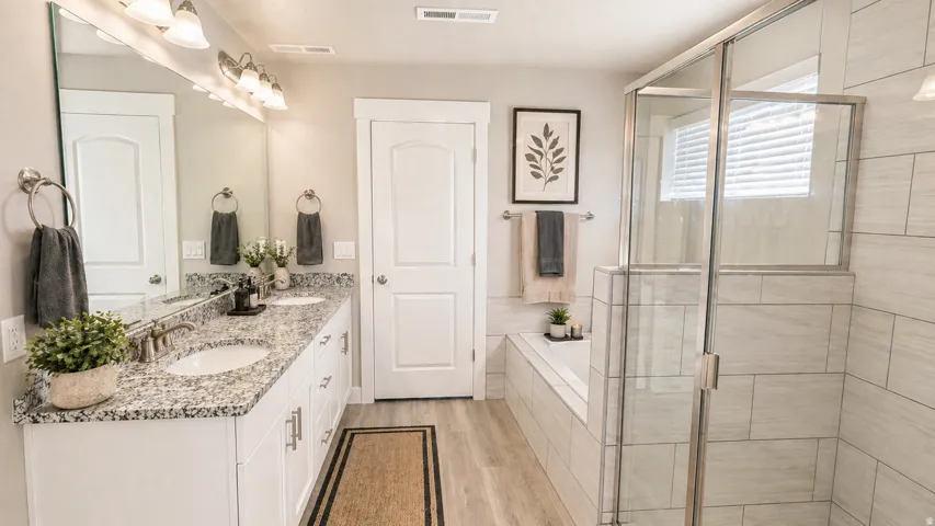 Virtually Staged Bathroom with a bath, double vanity, a shower stall, and light wood-style floors