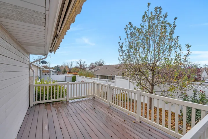 Trex deck with a fenced backyard and a residential view