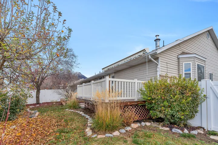 View of home's exterior featuring a fenced backyard, a gate, and a deck