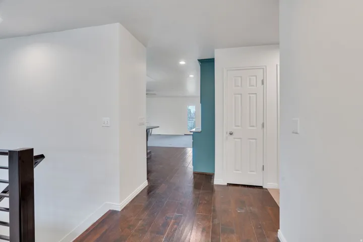 Entryway with dark wood flooring and recessed lighting