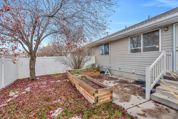 Fenced backyard with a garden