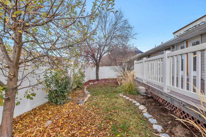 Fenced backyard featuring a deck