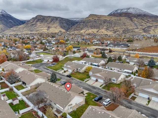 Aerial view of property's location featuring nearby suburban area and a mountainous background