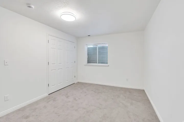 Spare room with light carpet and double door closet. Basement Bedroom #3