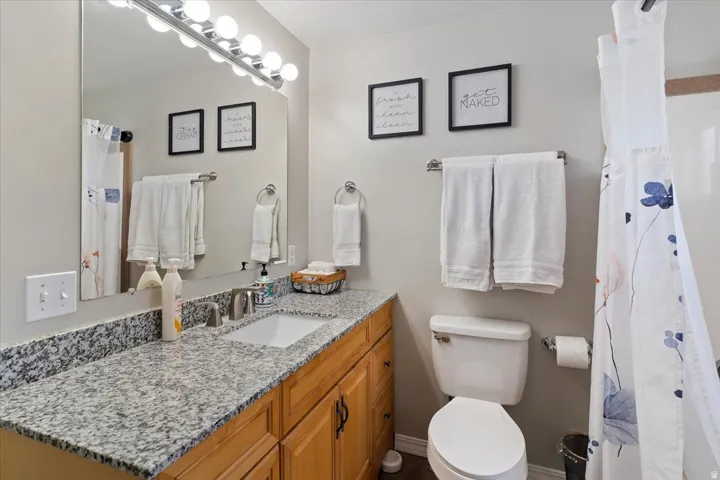 Bathroom with a shower curtain and vanity