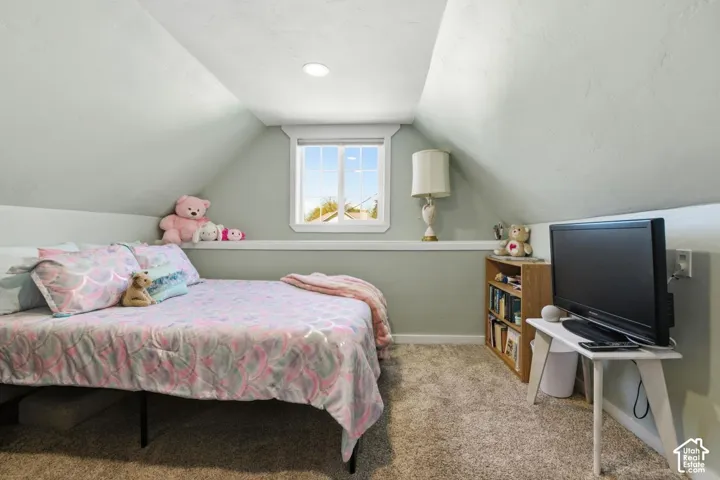 Bedroom with light carpet and baseboards