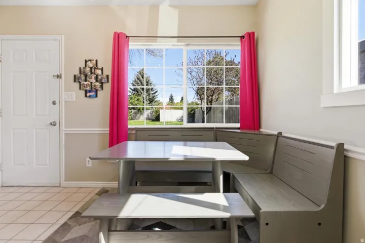 Dining room with light tile patterned floors and breakfast area