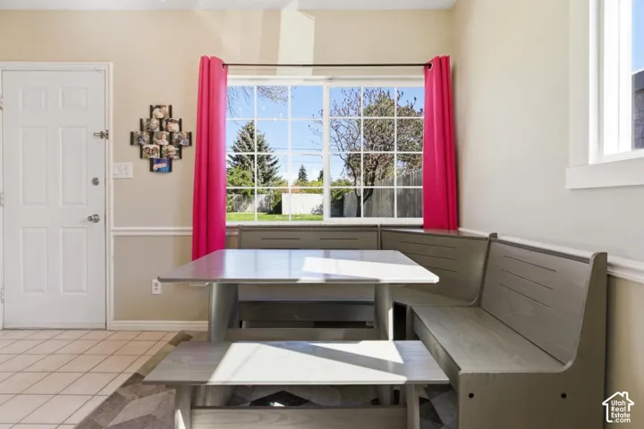 Dining room with light tile patterned floors and breakfast area