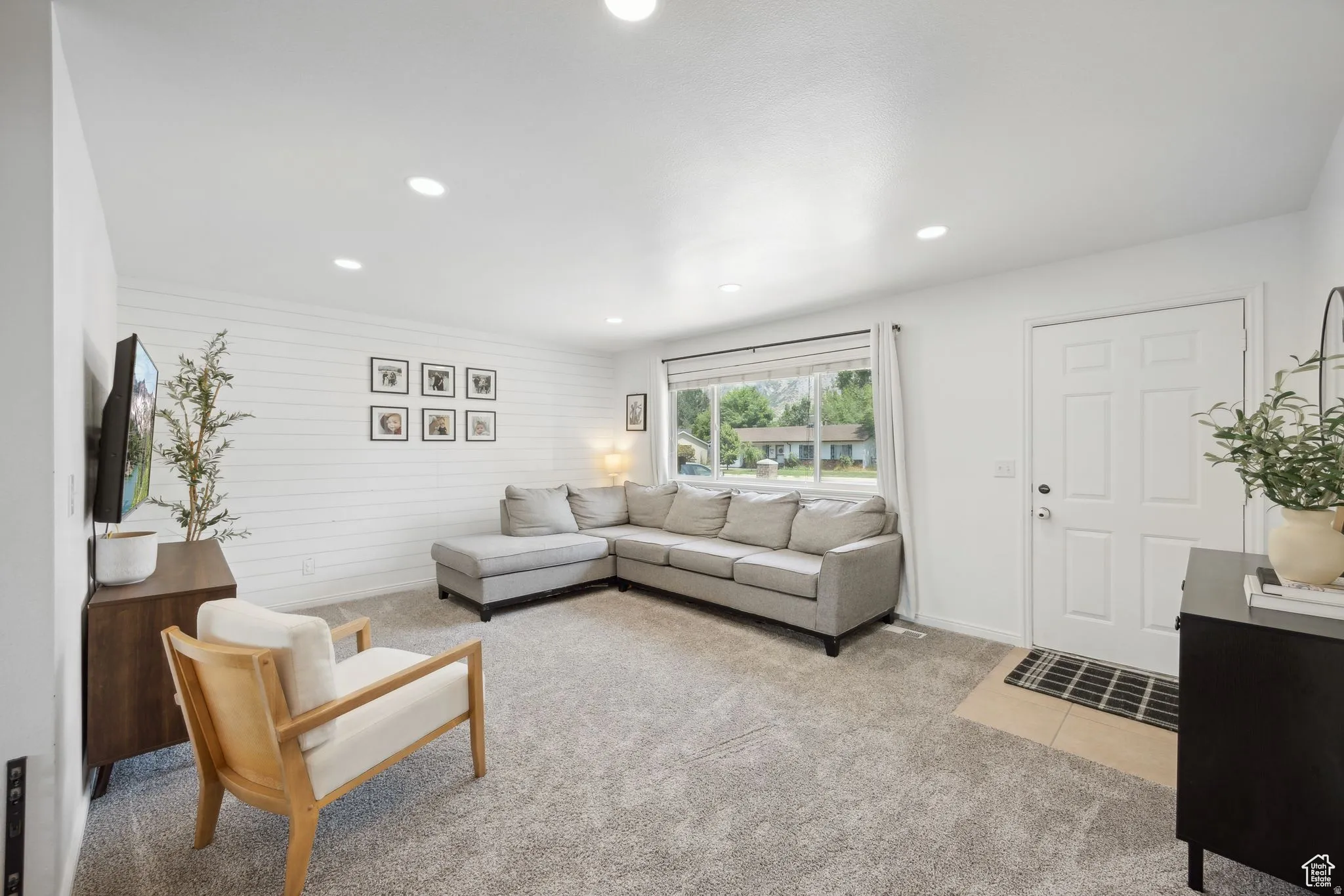 Living room featuring light colored carpet and recessed lighting
