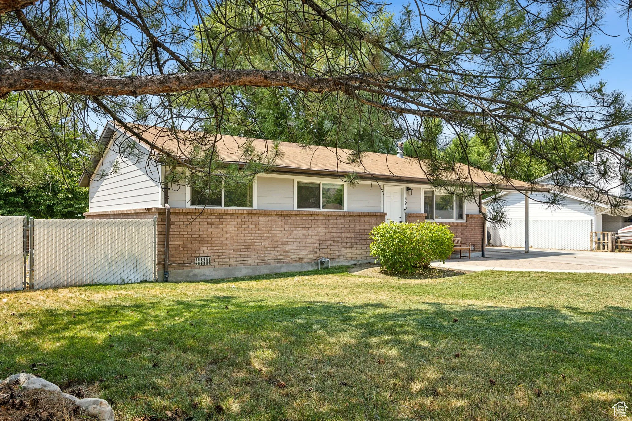 Ranch-style home with brick siding and a patio area