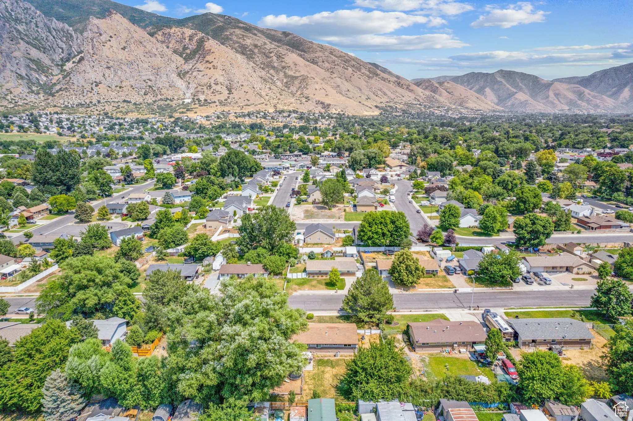 Aerial perspective of suburban area with a mountain backdrop