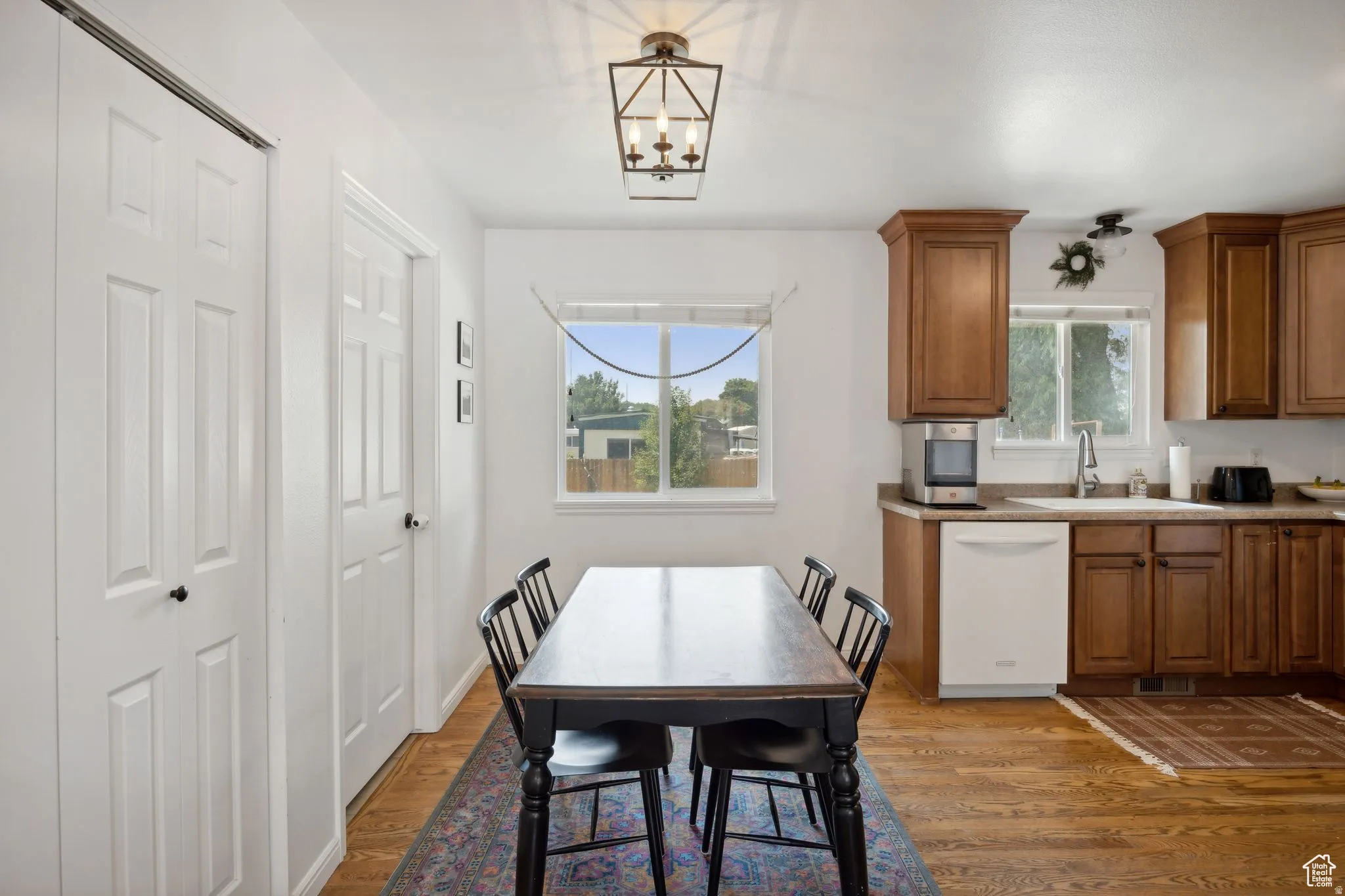 Dining space with dark wood-style flooring and hanging lights