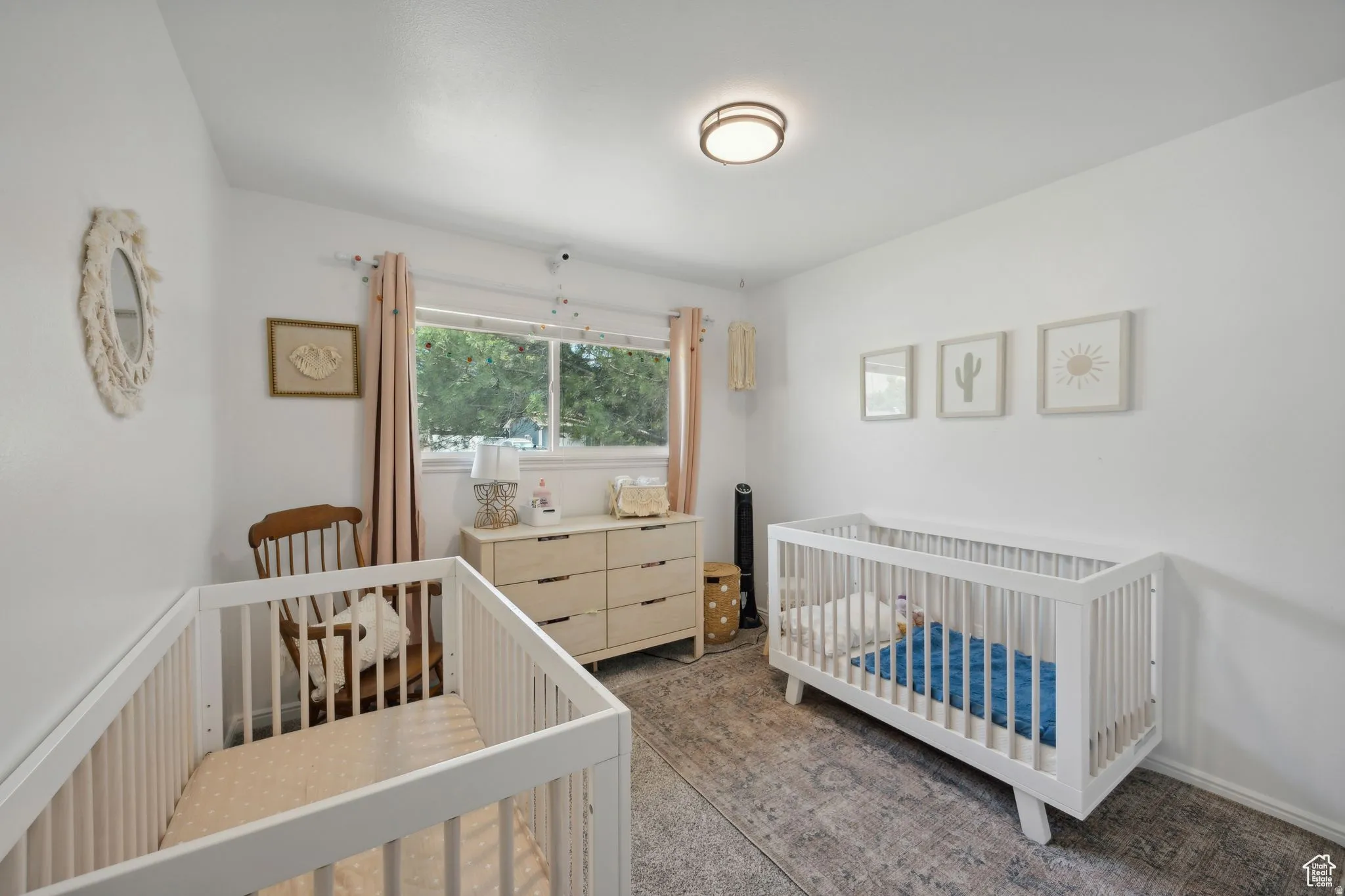 Bedroom featuring a crib and dark colored carpet
