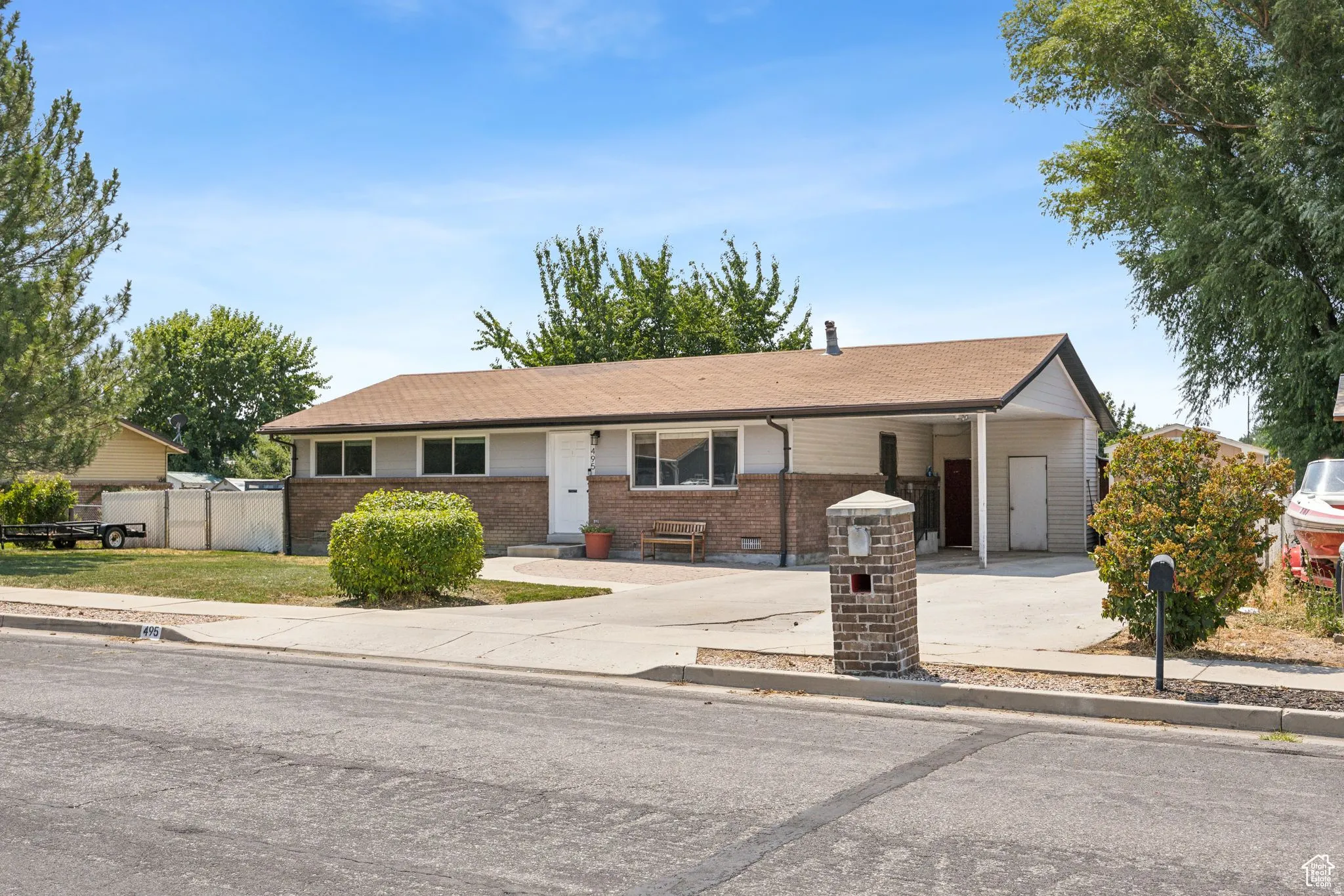 Single story home featuring brick siding and concrete driveway