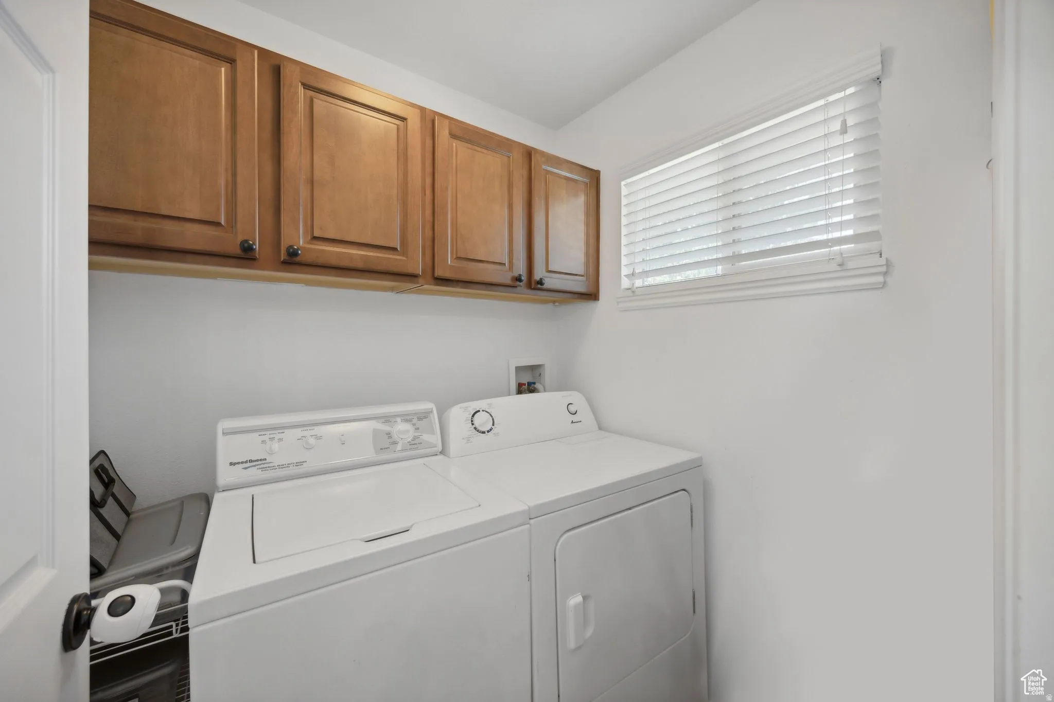Laundry area with cabinet space and washer and clothes dryer
