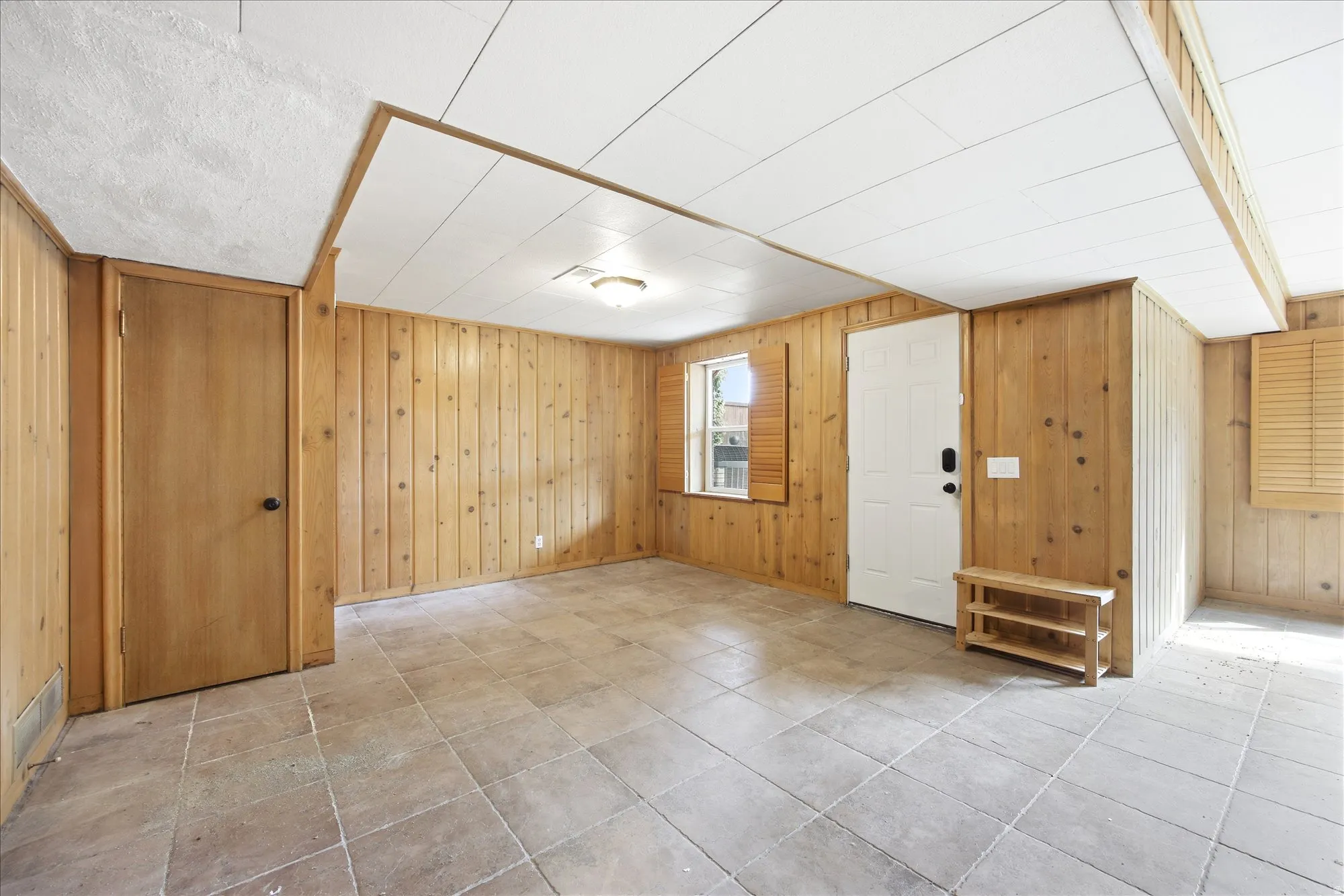 Entrance foyer featuring wooden walls