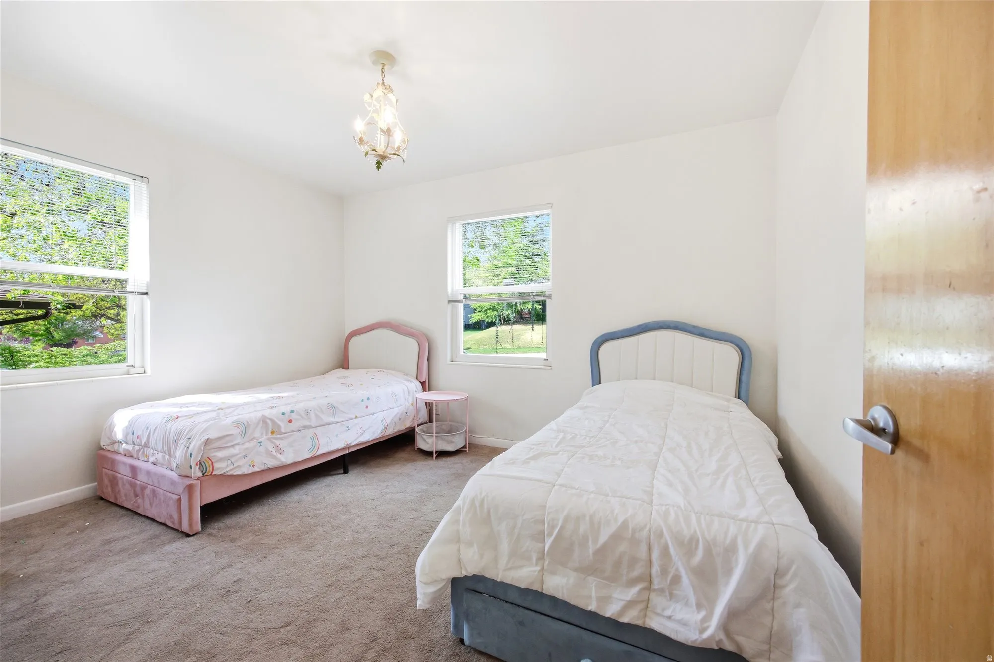 Bedroom featuring carpet and a chandelier