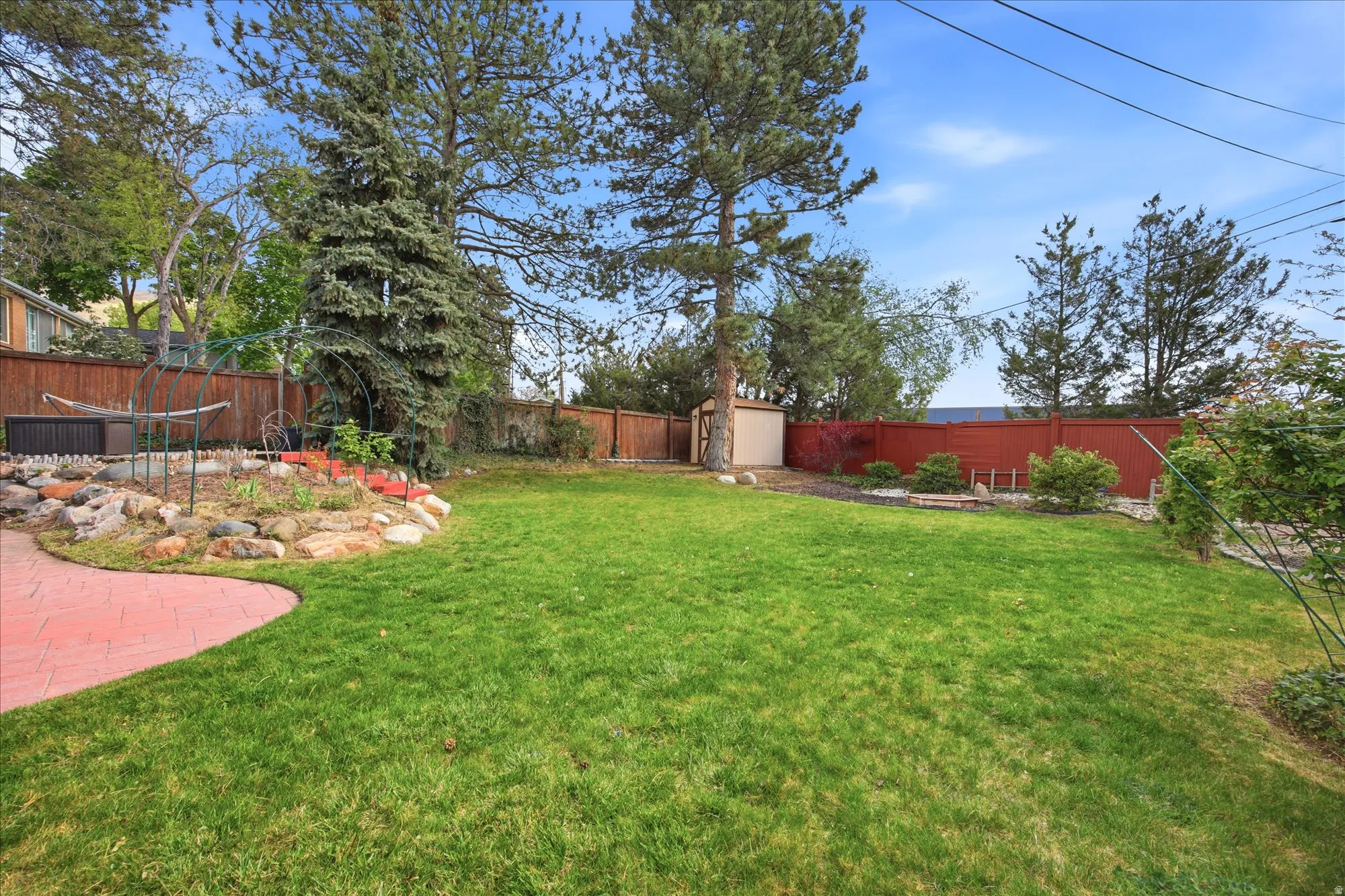 Fenced backyard with a storage unit