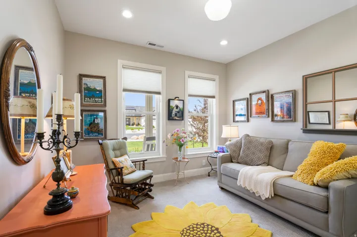 Living area featuring light colored carpet and recessed lighting