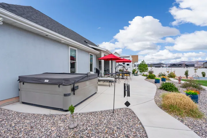 View of patio / terrace with a hot tub and outdoor dining area