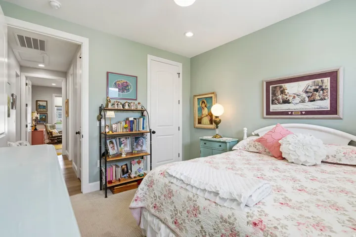 Bedroom featuring light carpet and recessed lighting