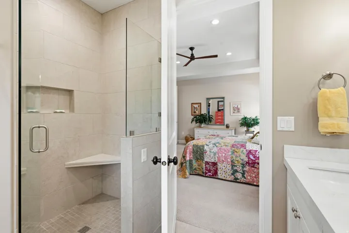 Full bath featuring ensuite bath, vanity, light colored carpet, recessed lighting, and a stall shower